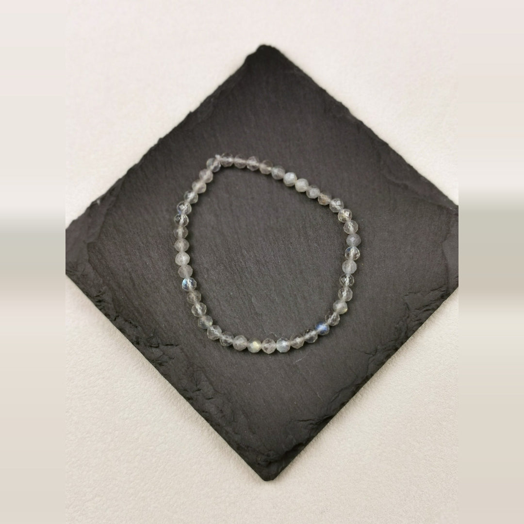 Armband aus facettierten grauen Iolithperlen mit 4 mm auf Schieferplatte