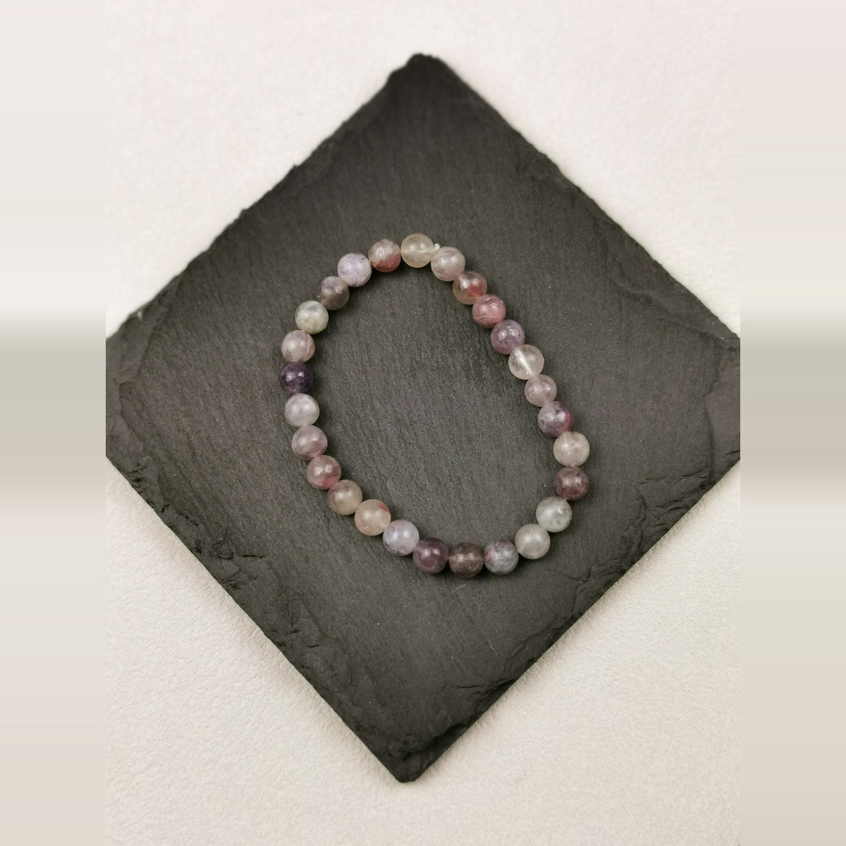 Armband aus runden Labradoritperlen mit 6 mm und blauem Schimmer auf Schieferplatte