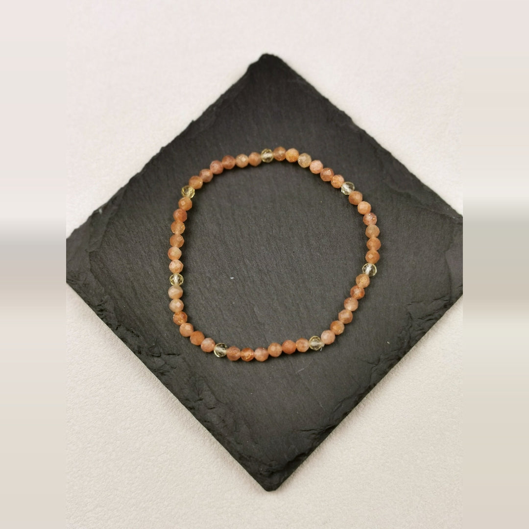 Armband aus facettierten Sonnenstein- und Citrinperlen mit 4 mm auf Schieferplatte