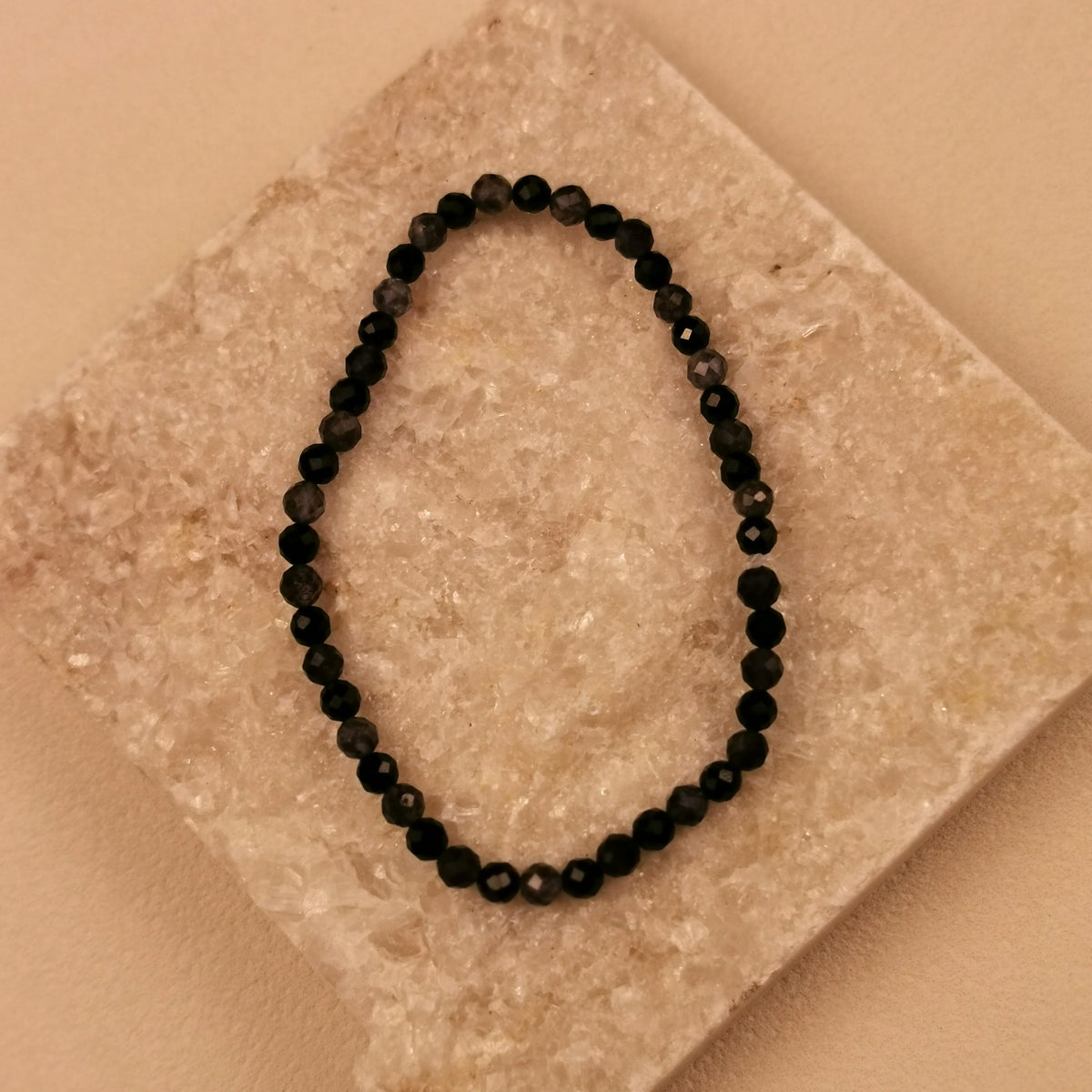 Armband aus facettiertem schwarzem Turmalin und graublauem Iolith mit 4 mm auf Schieferplatte